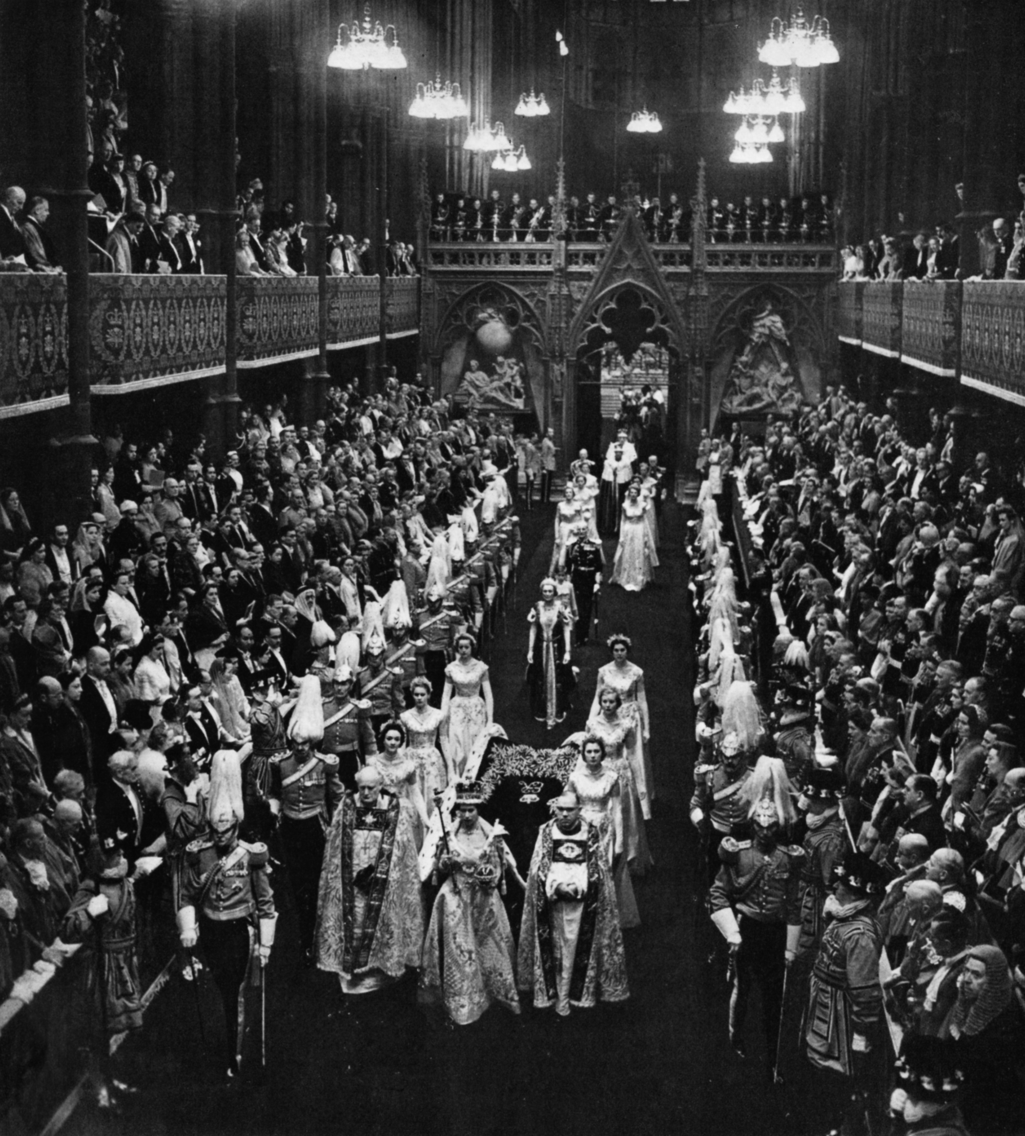 The newly crowned Queen Elizabeth II and her retinue parade down the aisle of Westminster Abbey