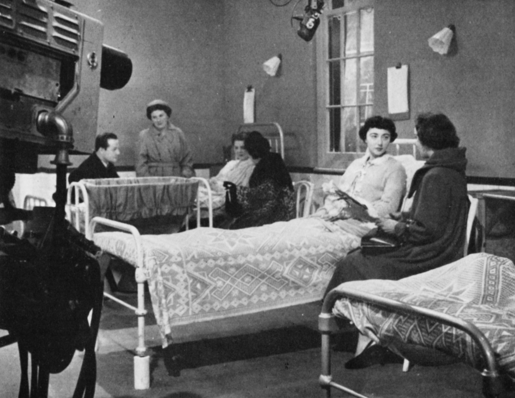 Women in a maternity hospital with visitors